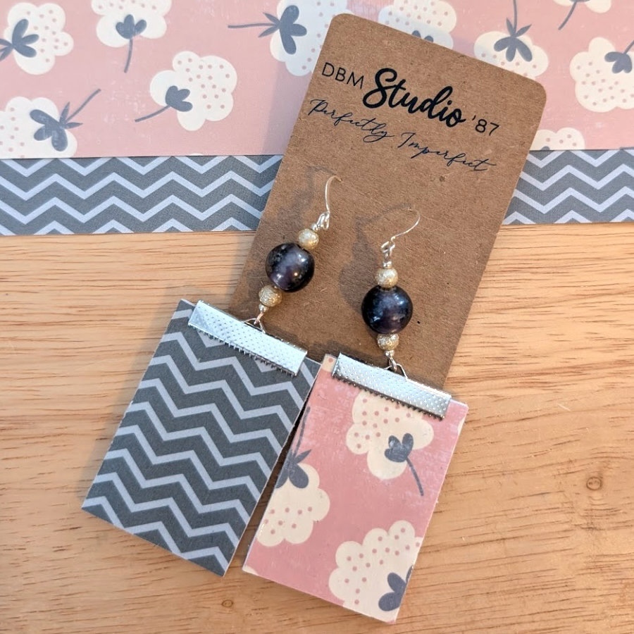 Medium rectangle dangle scrapbook paper earrings with silver accents and silver-purple pearlish beads. Salmon pink floral front; gray chevron back. Front and back shown.